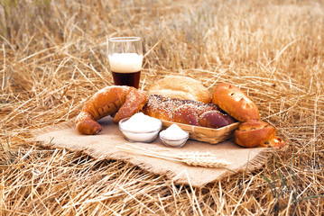 Glass of beer or kvass and breads on tablecloth