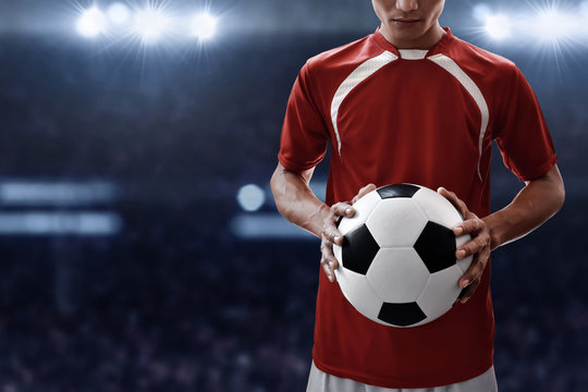 Soccer player holding soccer ball