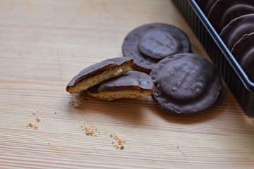 Chocolate coated biscuit cakes with the orange filling isolated over the white background