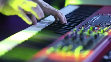 The musician playing the electric piano, Electric piano, Actor playing on the keyboard synthesizer piano keys. Musician plays a musical instrument on the concert stage. synthesizer
