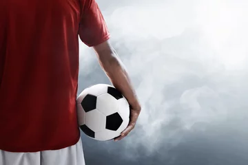 Türaufkleber Soccer player holding soccer ball © fotokitas