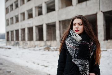 Fototapeta premium Brunette stylish casual girl in scarf against abandoned factory place.