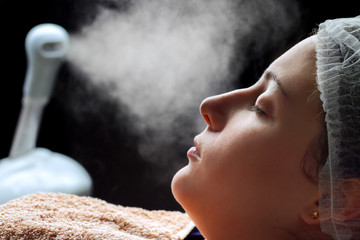 Beauty treatment of face skin with ozone facial steamer in spa center - obrazy, fototapety, plakaty