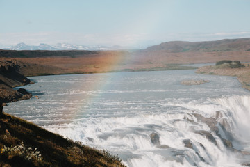 Fototapeta na wymiar beautiful scenic icelandic landscape with river, Gullfoss waterfall and rainbow