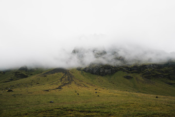 scenic view of grassy hills in fog, iceland