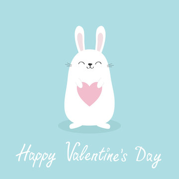 White bunny rabbit holding heart. Happy Valentines Day. Love greeting card. Funny head face. Cute kawaii cartoon character. Baby greeting card. Easter symbol. Blue background. Flat design.