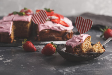 St.Valentine's Day Cake for breakfast with pink glaze and fresh strawberries. Dark background, berry dessert, copy space.