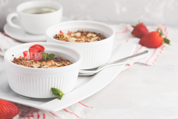 Homemade summer breakfast strawberry crumble. Mini berry cake with strawberry, light background. Healthy vegan food concept.
