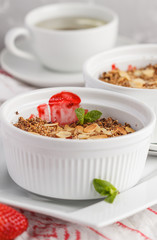 Homemade summer breakfast strawberry crumble. Mini berry cake with strawberry, light background. Healthy vegan food concept.