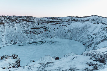 beautiful scenic landscape with majestic volcanic lake kerid in snow, iceland