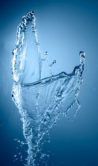 abstract blue color water splash isolated on empty clean background, studio photo 