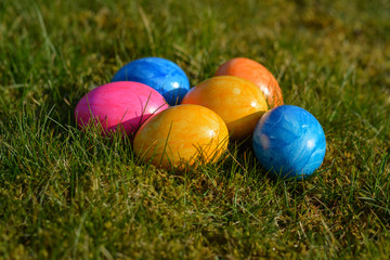 Several colorful Easter eggs lying on grass