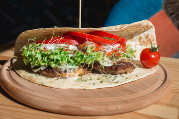 great mexican taco with meat schnitzel with cheese and vegetables