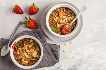 Homemade breakfast strawberry crumble. Mini berry cake with strawberry, light background, top view, copy space. Healthy vegan food concept.