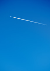 Vapour trail of a jet on a clear blue sky