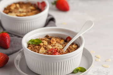 Homemade summer breakfast strawberry crumble. Mini berry cake with strawberry, light background. Healthy vegan food concept.