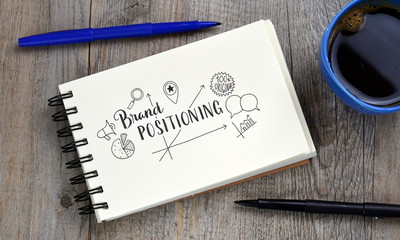 BRAND POSITIONING with icons on notepad