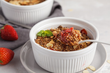 Homemade breakfast strawberry crumble. Mini berry cake with strawberry, macro, light background. Healthy vegan food concept.