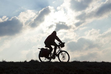 Obraz na płótnie Canvas Cyclist Against Overcast Sky