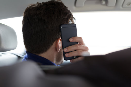 Man covering his face with phone from camera