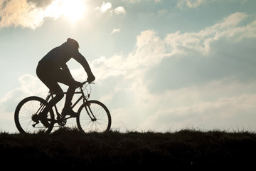 Obraz premium Cyclist Against Overcast Sky