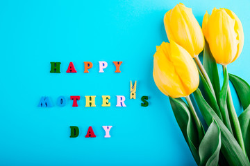 Happy Mother's day. Mother's Day concept. Lettering with yellow tulips