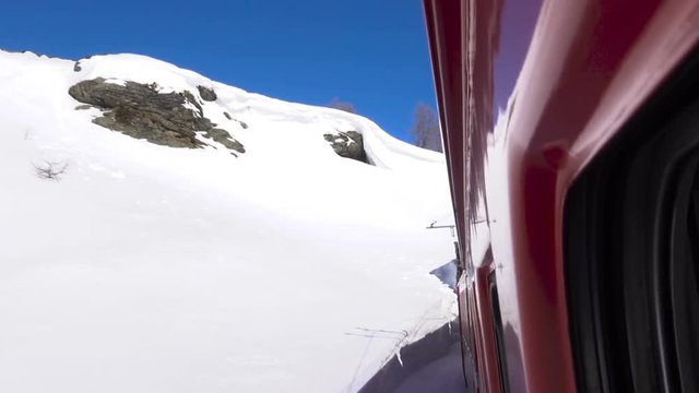 Red train on Bernina Pass in Winter season