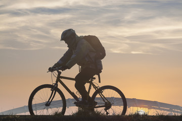 Fototapeta na wymiar Cyclist Against Overcast Sky