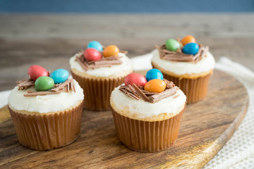 Easter cupcakes with chocolate frosting and candy eggs