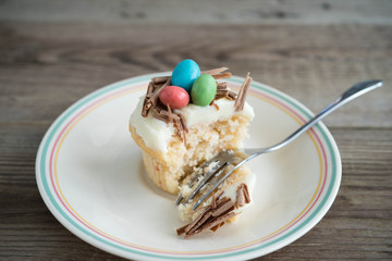 Easter cupcakes with chocolate frosting and candy eggs