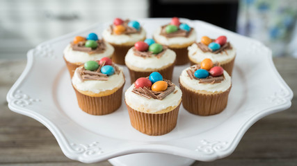Easter cupcakes with chocolate frosting and candy eggs