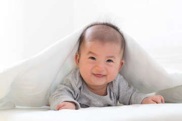Asian baby boy smile with white blanket