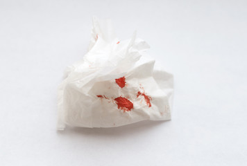 White napkin with blood on a white background.