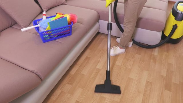 Top view on woman who clean floor with vacuum cleaner 
