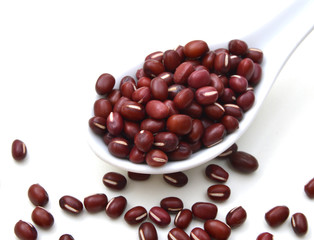 red beans in spoon on white background