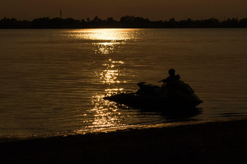 The jet ski with sunset in evening and the lagoon in thailand.