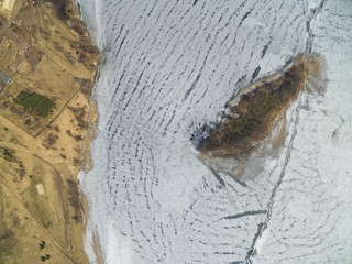 Aerial view of an island on frozen Swiecajty Lake in Masuria District, Wegorzewo, Poland