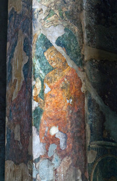 Ancient painted fresco with Buddha at the column in Ajanta caves, Maharashtra, India