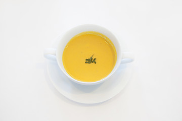 Obraz na płótnie Canvas Bowl of pumpkin soup isolated on a white background