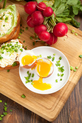 Boiled egg with crunchy bread and healthy vegetables for breakfast