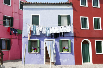 Burano island, Venice, Italy - typical turquoise house with hanging clothes