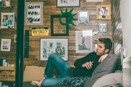 Boy resting on the couch at home. Social network style photo. Relaxed lifestyle