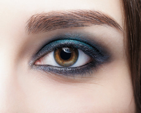 Closeup macro shot of  human female eye. Woman with natural evening vogue face beauty makeup