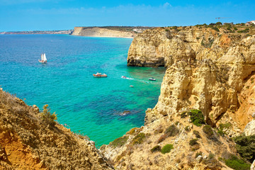 Fototapeta na wymiar Cliff rocks and sea bay with turquoise water in Lagos, Algarve region, Portugal