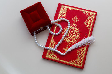 Holy book for Muslims. Quran and rosary concept. Ramadan concept. Three months. 