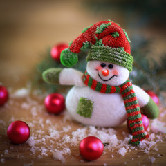 Christmas card. toy snowman on a festive background.