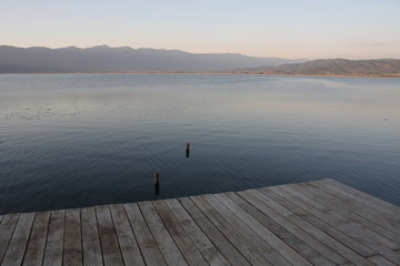 Wooden pier with blue sea and sky background