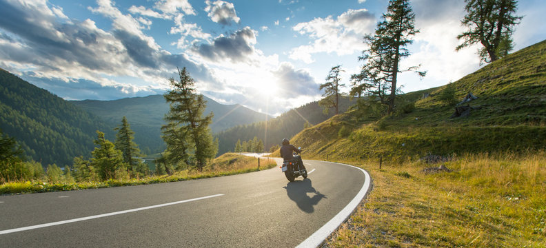 Motorcycle driver riding in Alpine highway, Nockalmstrasse, Austria, Europe. © Lukas Gojda