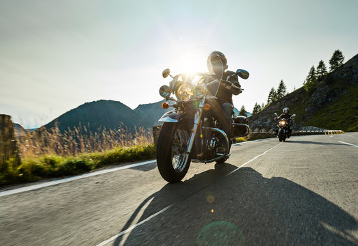 Fototapeta Motorcycle driver riding japanese high power cruiser in Alpine highway on famous Hochalpenstrasse, Austria.