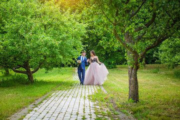 Happy wedding couple walking in park